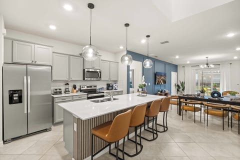 Elegant kitchen and dining area with modern amenities, perfect for hosting and entertaining in style.