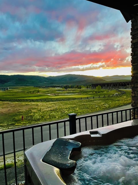 View of the golf course and mountains from our deck with a private hot tub