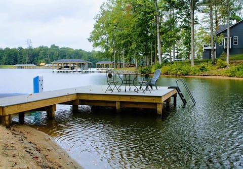 Dock - Bistro table and chairs on the dock invite you to dine lakeside, with a swim ladder for easy water access.