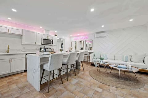 A chic and inviting open-concept space with modern elegance, warm textures, and a touch of glam.