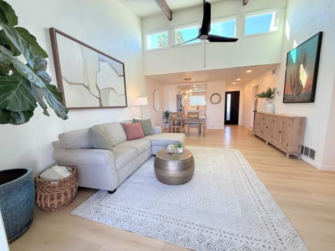 Spacious open-concept living area with high ceilings, abundant natural light, and modern furnishings in Old Town Scottsdale.