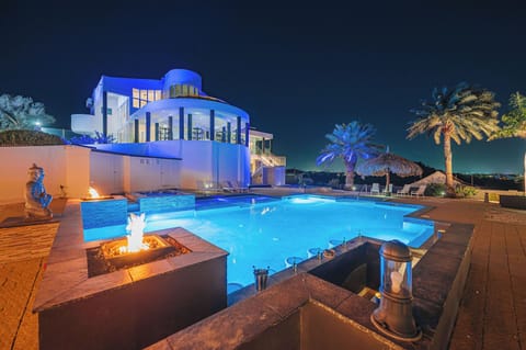 Nightfall never looked this extraordinary Villa Royale’s pool, terraces, and villa glow with unrivaled elegance.