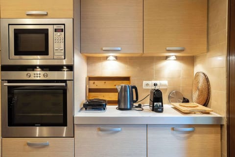 Functional Kitchen Area with Built-In Oven and Storage