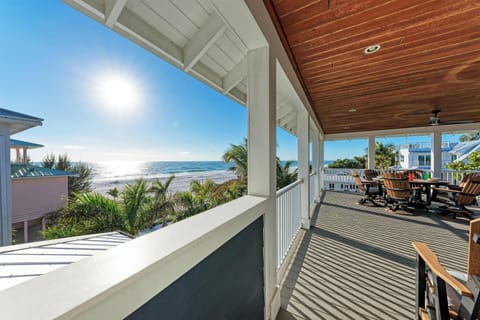 Spacious covered balcony offers stunning ocean views and comfortable seating for your perfect beachside retreat.