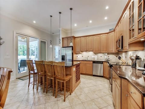 Alternate kitchen view showcases generous prep space, pendant lighting, and seating that accommodates larger gatherings.