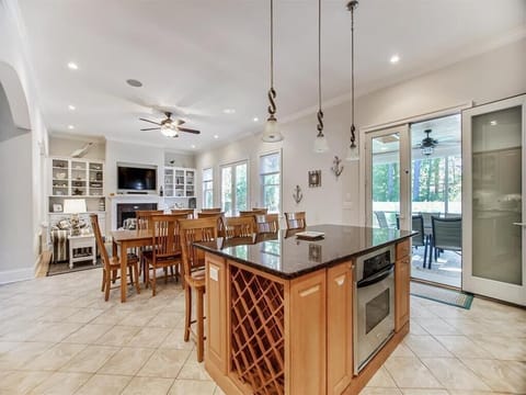 Bright kitchen and dining area offers ample counter space, bar seating, and an easy flow for entertaining.