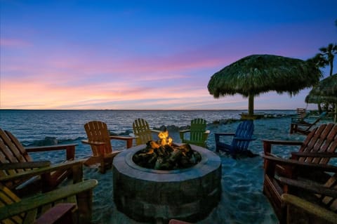 Sunset fire pit surrounded by Adirondack chairs and ocean views
