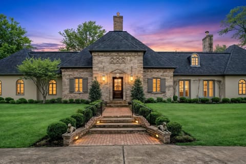 Pull up at dusk and you'll know you made the right
call — this stone French-country manor lit against a purple Kentucky sky is the arrival moment your group will talk about all weekend.