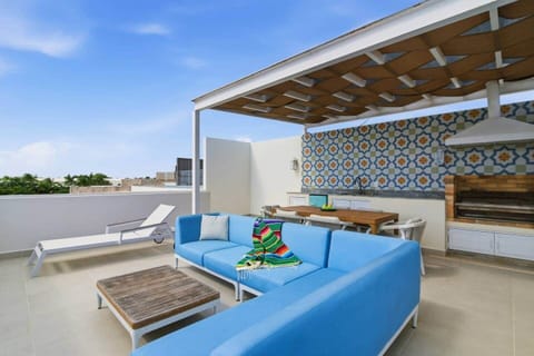 Your private rooftop terrace with Caribbean Sea views, perfect for relaxing. Enjoy outdoor lounge seating and a sun lounger, gather at the dining table for six, fire up the BBQ grill, enjoy drinks from the mini fridge, and unwind under soft lights.