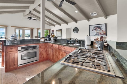 Fully stocked kitchen with cookware and serve ware