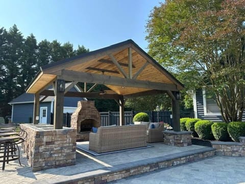 Lovely pergula with seating and a real wood-burning fireplace