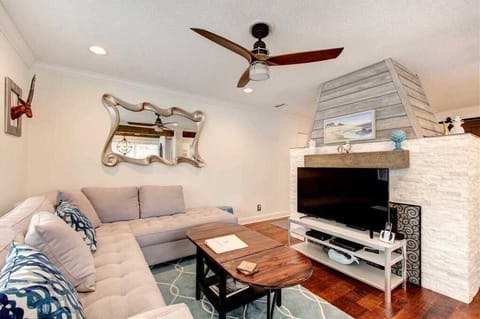 Living room area with sectional sofa and fireplace.