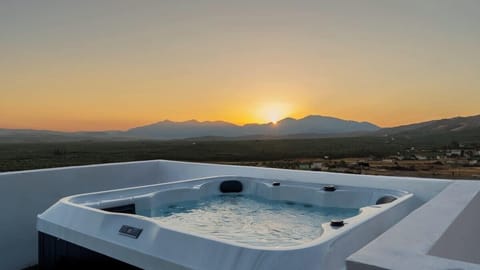 A private hot tub at sunset, where the sky melts into the mountains.