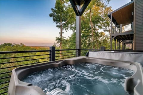 Soak in the bubbling hot tub while watching stunning sunsets paint the sky over treetops—pure relaxation awaits you here.