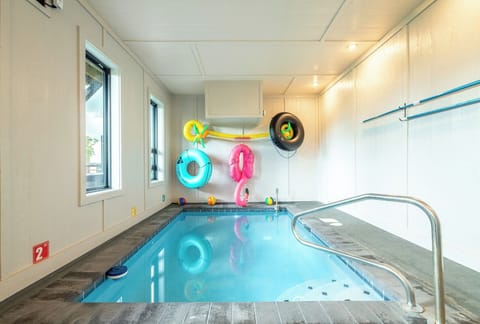 Your private indoor pool awaits, complete with colorful floats and crystal-clear water—perfect for splashing around any time of day, rain or shine.