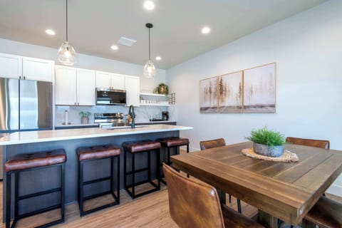 Gather around the island and dining table in this open kitchen space.
