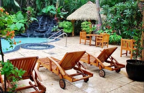 Zen Oasis Lava rock heated pool and hot tub with a stunning waterfall. 