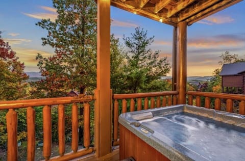 An intimate covered balcony retreat with a private hot tub overlooking layers of fall-colored mountain ridges. Uninterrupted views create a secluded escape designed for relaxation after a day of exploring the Smokies.
