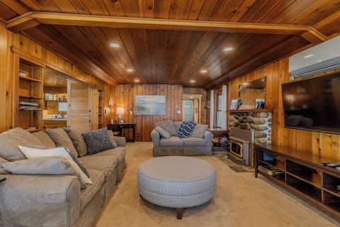 Living Room - The far doorway leads to the bedrooms and bathrooms. The dining room is off to the immediate left and the kitchen is left of the fireplace.