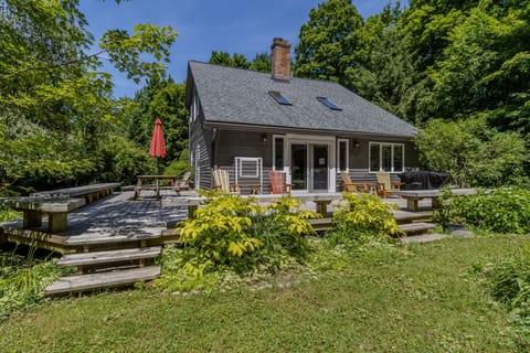 Exterior - Back deck area with plenty of seating and grill. Setting is forested and peaceful.