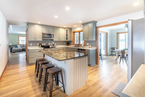 Kitchen - Full, well equipped kitchen has two dining areas: one looks out on the backyard, the other looks out on the front yard directly across the kitchen from the first dining room.