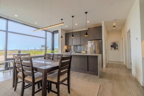 Lower Level - Dining Room - Dining room area with additional high-top table overlooking the river. Hallway leads to bedrooms and bathrooms.