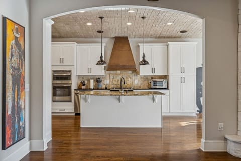 Entrance to Kitchen from Living Room with curved hand crafted ceiling