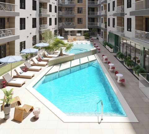 Elevated view of the resort offers a communal pool, outdoor kitchen, and multiple lounge areas.