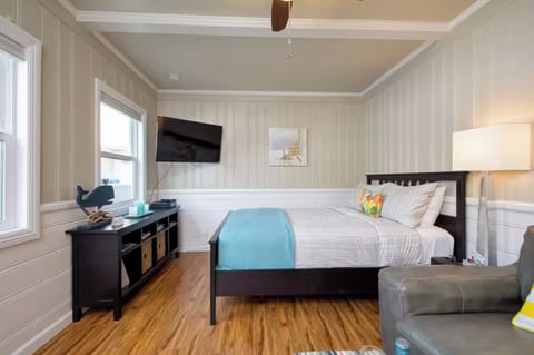Cozy studio space with a plush bed and calming décor for a restful stay.