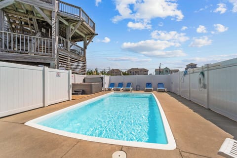 Dive into your private pool surrounded by comfortable lounge chairs, perfect for soaking up the sun in complete privacy.
