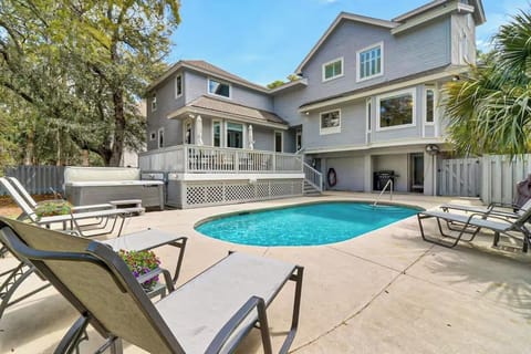 Stunning coastal home with private pool surrounded by tropical palms and spacious deck for ultimate relaxation.