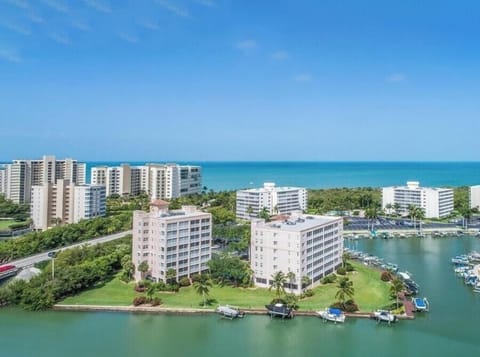 Waterfront complex with marina access overlooking turquoise waters and pristine beaches.