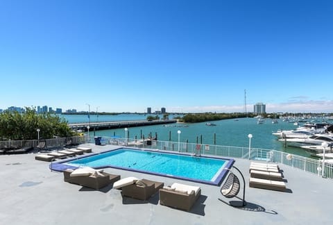 Lounge by the rooftop pool with sweeping views of the marina and skyline—perfect for sunseekers.