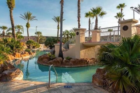 Shared pool area with lazy river, water slide, and hot tub