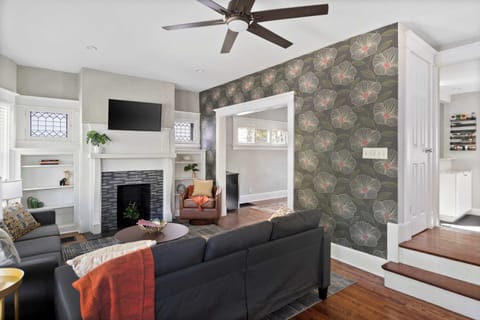 Stylish living room w/ comfy seating, TV & bold accent wall