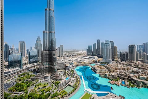 Cinematic View: Witness the full majesty of Downtown Dubai from your exclusive vantage point in the Grande tower. This daytime exterior view showcases a breathtaking, panoramic skyline and the magnificent Burj Khalifa.