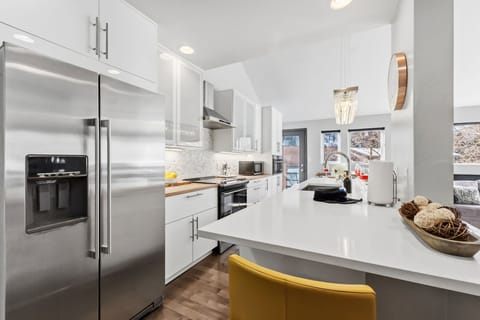 Updated kitchen with stainless steel appliances and everything needed to cook a meal at the home after a day in the mountains.