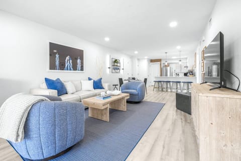 Spacious open-concept living area with comfortable seating and a bright, airy layout.