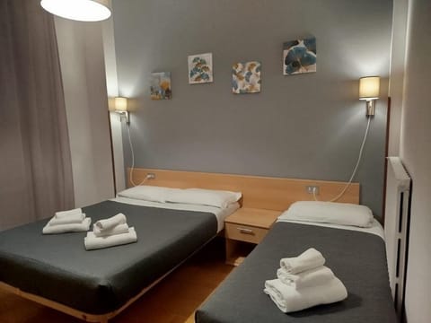 Standard Triple Room, Balcony, City View | In-room safe, desk, laptop workspace, blackout drapes