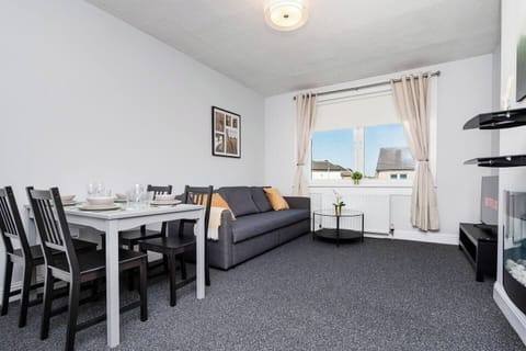 Relax and unwind in this comfortable living room designed for both rest and entertainment.