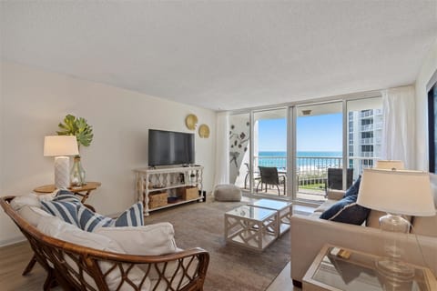 Relax in your coastal living room with stunning ocean views from the private balcony. Comfortable seating and beach-inspired decor create your perfect seaside retreat.