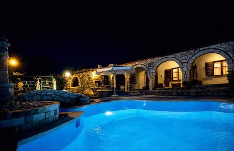 The pool area beautifully illuminated at night, creating a relaxing atmosphere for evening swims and outdoor moments.