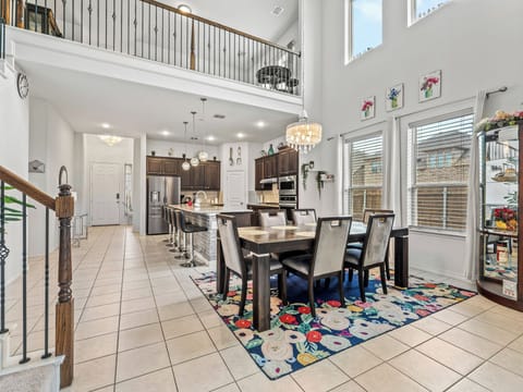 Relax in this stunning open-concept space where soaring ceilings and elegant chandeliers create the perfect gathering spot for your group.