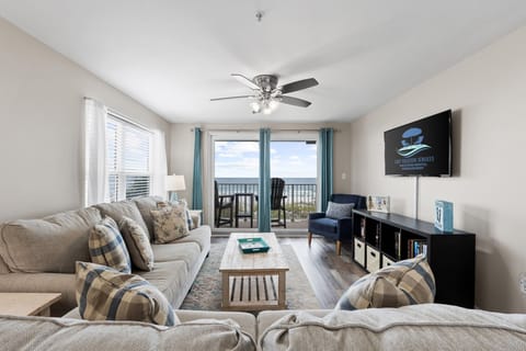 Cozy living room with natural light and beautiful ocean views just outside