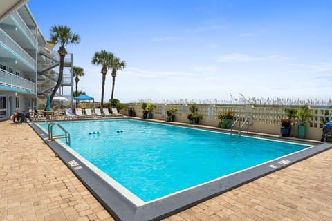 Resort swimming pool with lounge chairs.