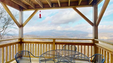 Covered deck with mountain panoramas and outdoor dining for memorable meals with a view.
