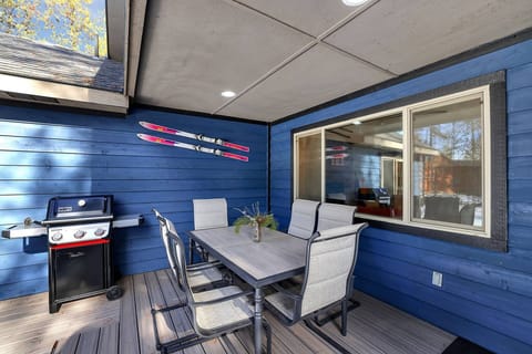 Covered back deck with outdoor dining table - dine al fresco surrounded by the pines