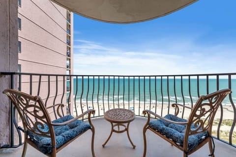 Oceanfront balcony with cozy seating and panoramic beach views — your front-row seat to sunrise, sea breezes, and endless blue horizons. ☀️