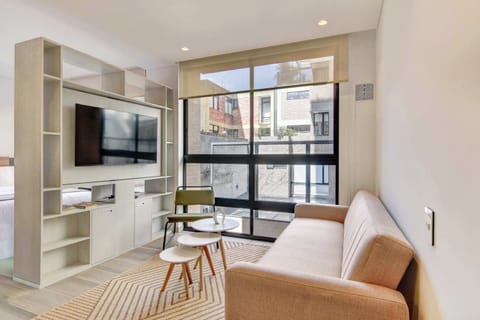Bright and modern living area with large windows and plenty of natural light.

