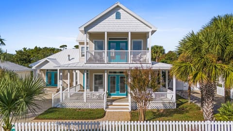 How inviting is this double-door entry and classic porch for your beach retreat?